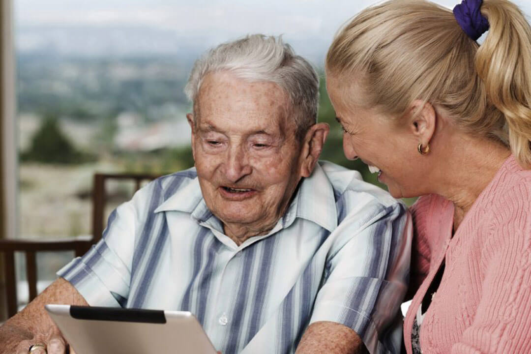 Caregiver assisting elderly man