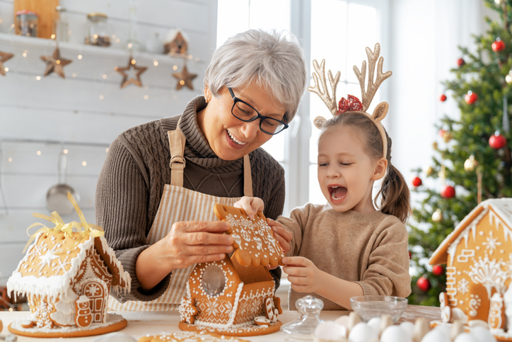 Senior woman cooking Christmas food with a child