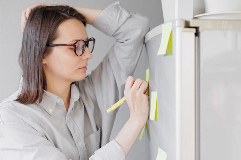 woman writing on post-it notes